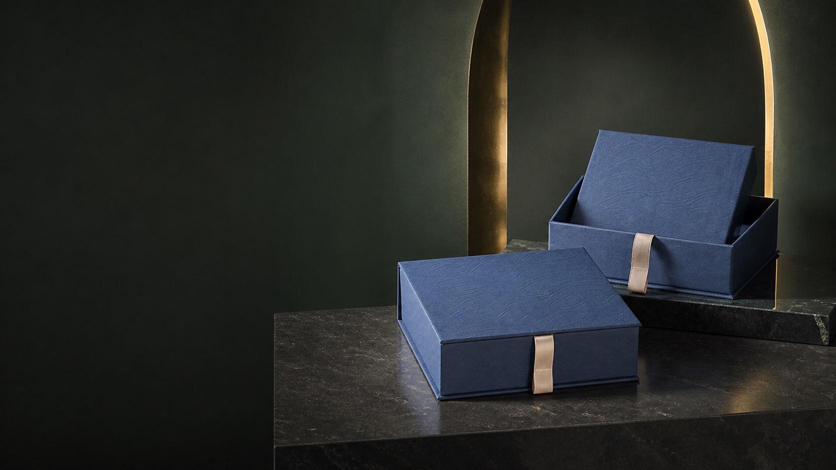 Gift Boxes arranged in a dark green editorial studio